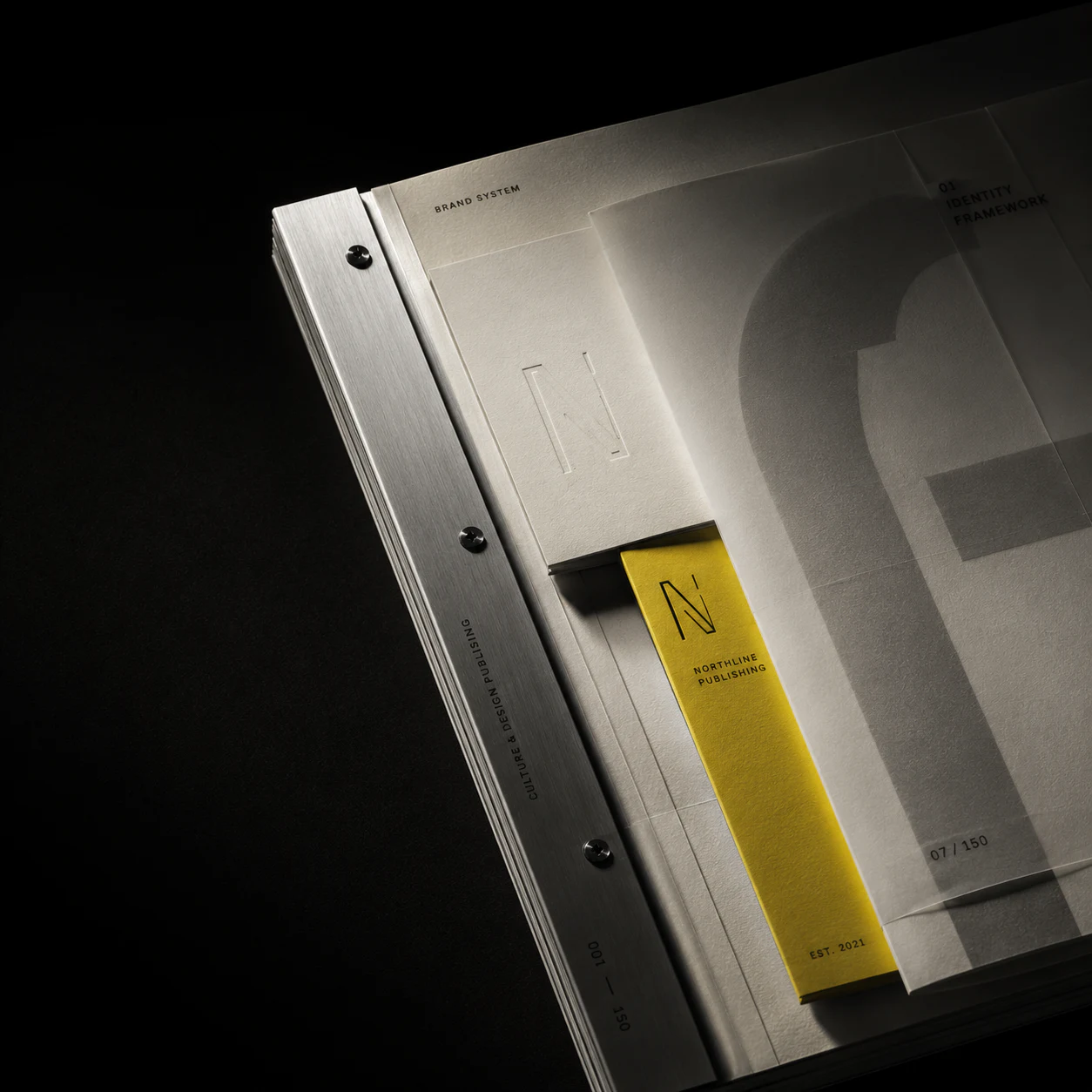 Northline Publishing brand-system book with metal binding and a yellow page marker